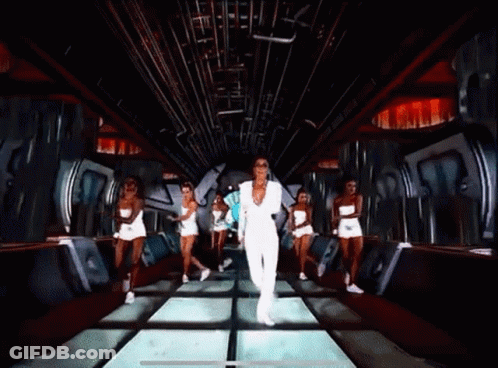 Woman In White Suit Dancing With Group In White Shorts GIF