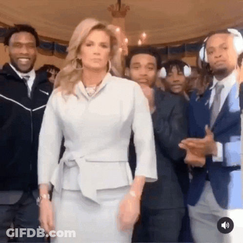 Woman In White Suit In Front Of Men GIF