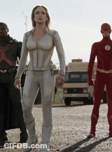 Woman In White Suit Next To Men In Red And Black Suits GIF