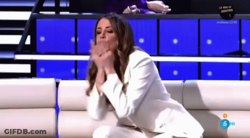 Woman In White Suit On Couch Hands Folded GIF