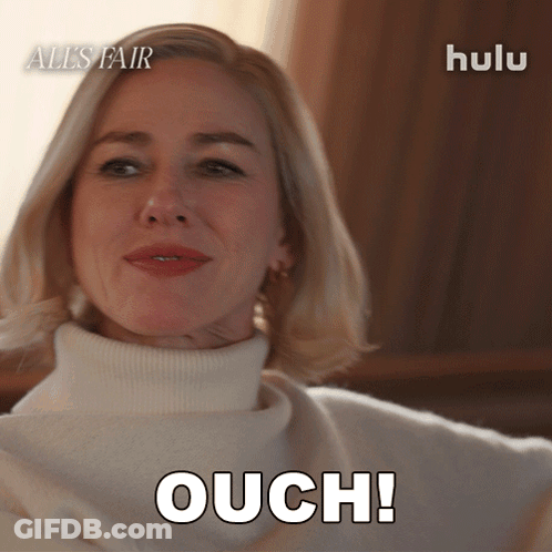 Woman In White Sweater Says Ouch GIF