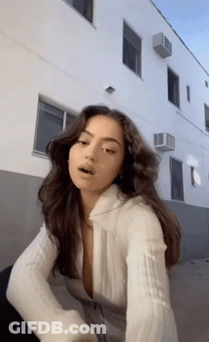 Woman In White Sweater Standing GIF