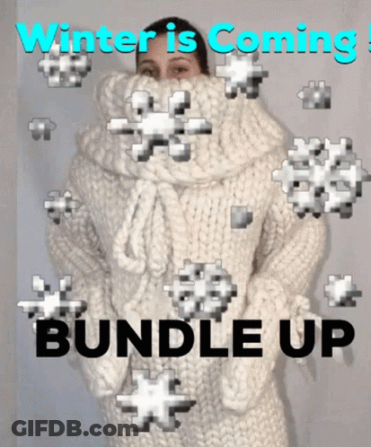 Woman In White Sweater Surrounded By Snowflakes Winter Is Coming Bundle Up GIF