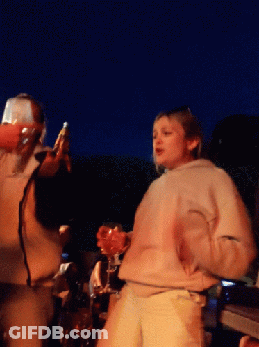 Woman In White Sweatshirt Holding Wine Glass GIF