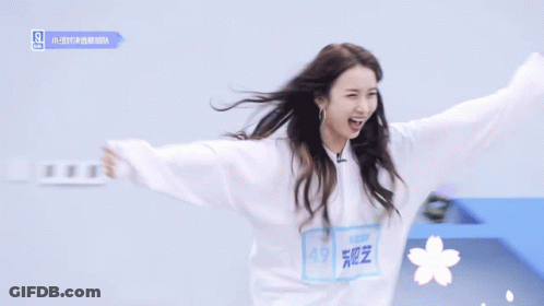 Woman In White Sweatshirt With Flower GIF