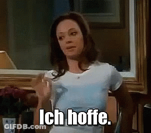Woman In White T-Shirt Holding Glass Of Water Saying Ich Hoffe GIF