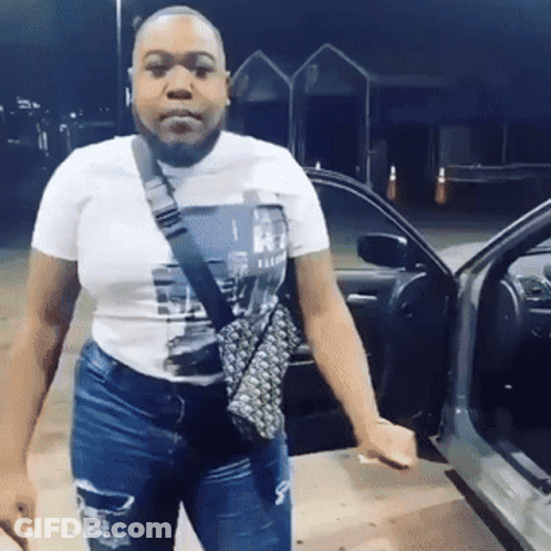 Woman In White T-Shirt In Front Of Car GIF