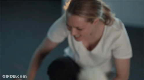 Woman In White T-Shirt Kneeling On Floor GIF