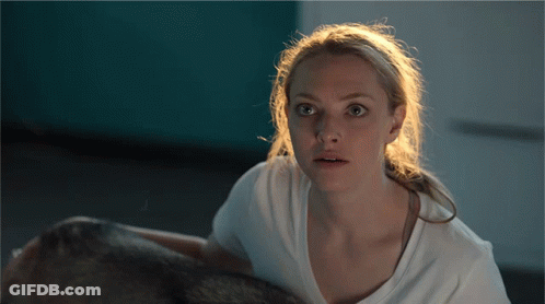 Woman In White T-Shirt Looking At Camera GIF