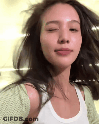Woman In White Tank Top And Green Cardigan GIF