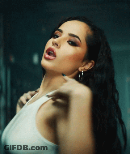 Woman In White Tank Top And Hoop Earrings Looking At Camera GIF