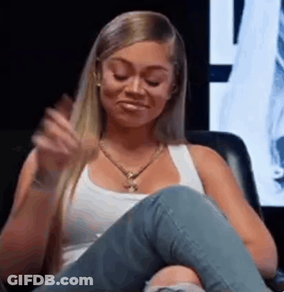 Woman In White Tank Top And Jeans Sitting Crossed Legs GIF