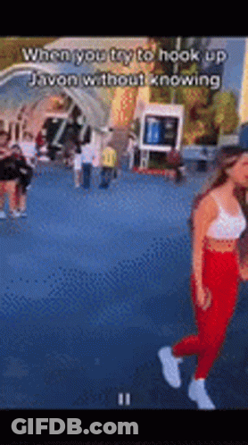Woman In White Tank Top And Red Pants Walking GIF