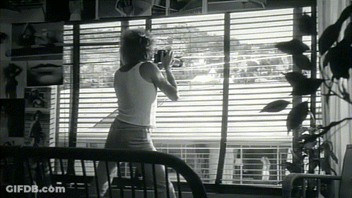 Woman In White Tank Top By Window GIF