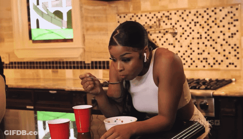 Woman In White Tank Top Eating Bowl Of Food GIF