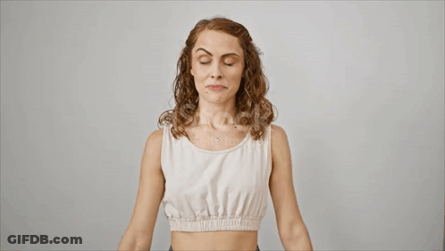 Woman In White Tank Top Flexing Biceps GIF
