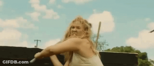 Woman In White Tank Top Holding Sword With Funny Face GIF