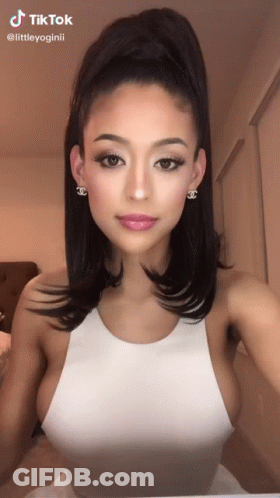 Woman In White Tank Top, Ponytail, Chanel Earrings GIF