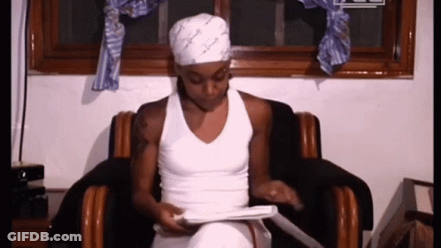 Woman In White Tank Top Sitting In Chair GIF