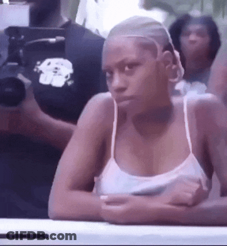 Woman In White Tank Top Sitting With Arms Crossed GIF