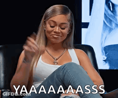 Woman In White Tank Top Sitting With Yaaaa Aaass Text GIF