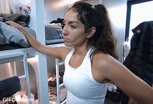 Woman In White Tank Top Standing In Room GIF
