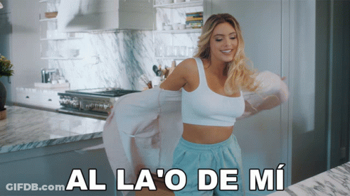 Woman In White Top And Blue Shorts Dancing In Kitchen Al La O De Mi GIF