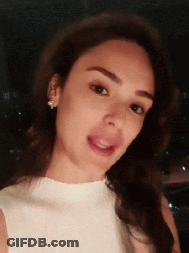 Woman In White Top And Earrings Smiling GIF