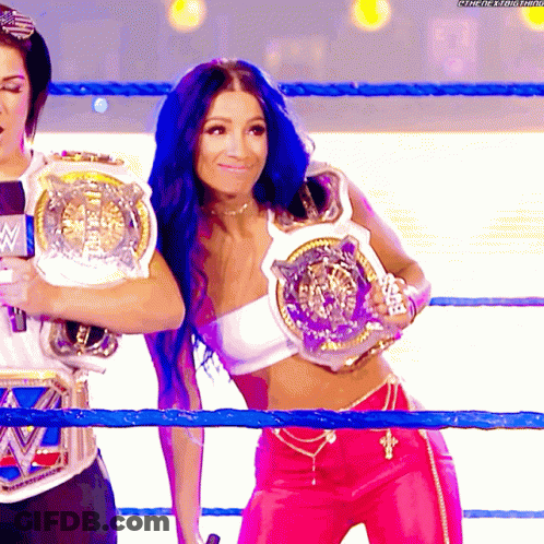 Woman In White Top And Pink Pants Holding WWE Belt GIF