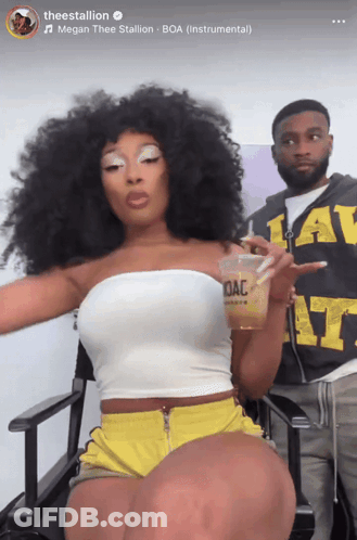 Woman In White Top And Yellow Shorts Holding OAC Cup GIF