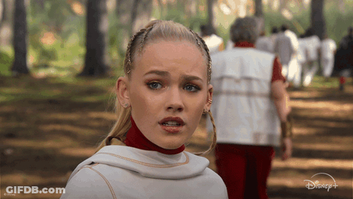 Woman In White Top In Woods With Disney Logo GIF