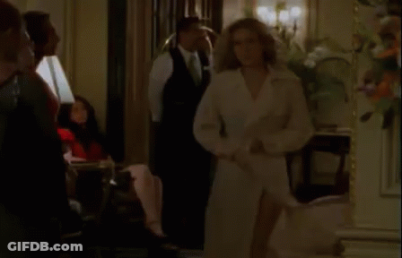 Woman In White Trench Coat Standing In Room GIF