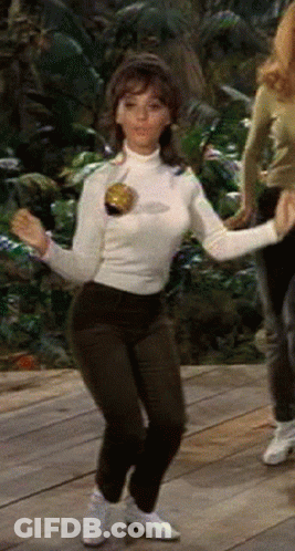 Woman In White Turtleneck Dancing On Wood Floor GIF