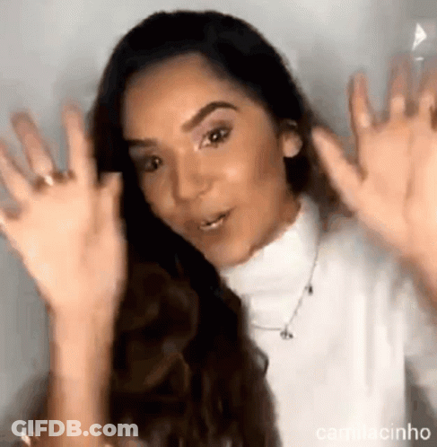 Woman In White Turtleneck Waving Hands GIF