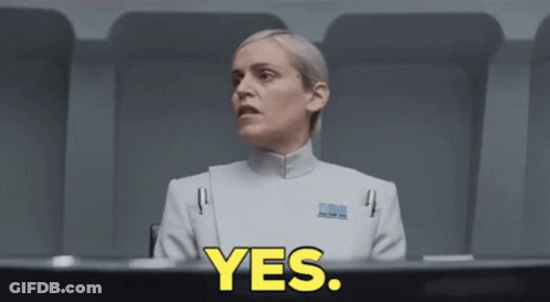 Woman In White Uniform Sitting At Table With Yes In Yellow GIF