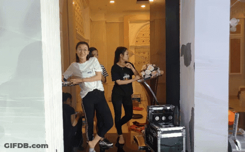Woman In White Vans Shirt Standing In Doorway GIF