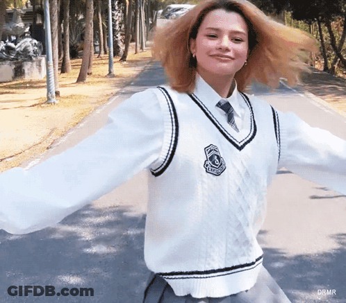 Woman In White Vest And Tie With Drmr Badge GIF