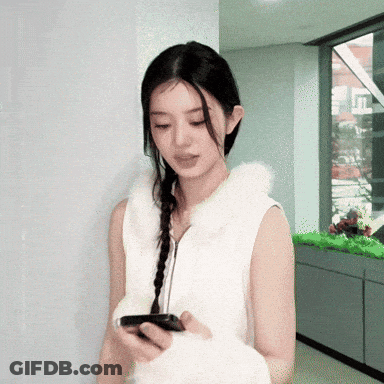 Woman In White Vest Looking At Cell Phone GIF