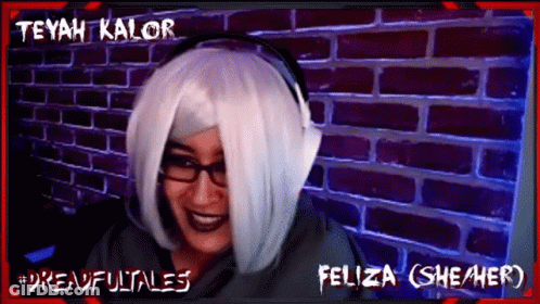 Woman In White Wig And Headphones Smiling In Front Of Teyah Kalor Brick Wall GIF