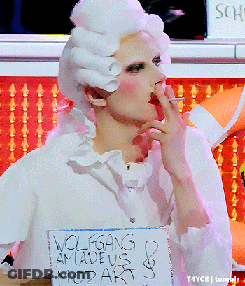 Woman In White Wig Smoking Holding Wolfgang Amadeus Mozart Sign GIF