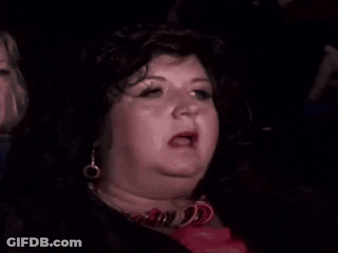 Woman In Wig And Earrings Making Funny Face GIF