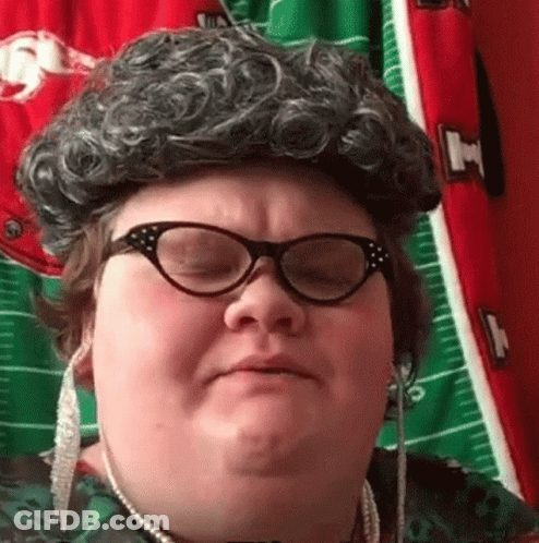 Woman In Wig And Glasses Making Funny Face GIF