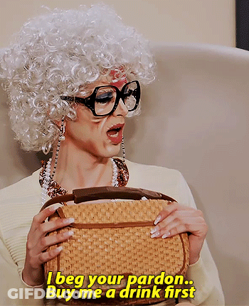 Woman In Wig And Glasses Saying I Beg Your Pardon Buy Me A Drink GIF