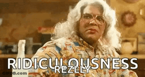 Woman In Wig And Glasses With Spray Bottle GIF