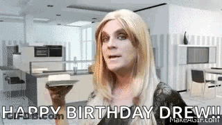 Woman In Wig Holding Book Says Happy Birthday Drew GIF