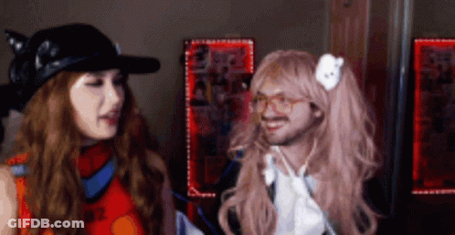 Woman In Wig Next To Man GIF