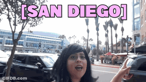 Woman In Wig On Street Saying San Diego GIF