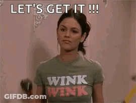 Woman In Winking Shirt Holding Drill And Hammer GIF
