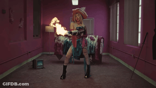 Woman In Witch Costage Holding Flame GIF