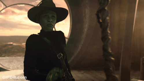 Woman In Witch Costume By Large Window GIF
